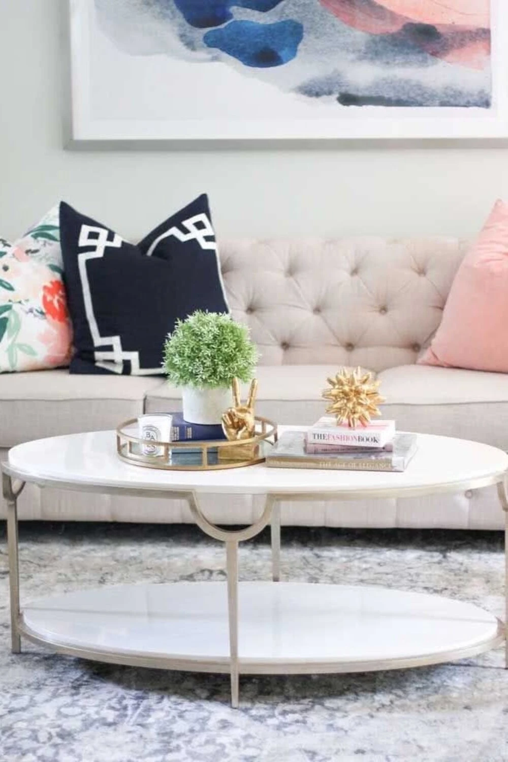 an oval coffee table with metal tray and figures
