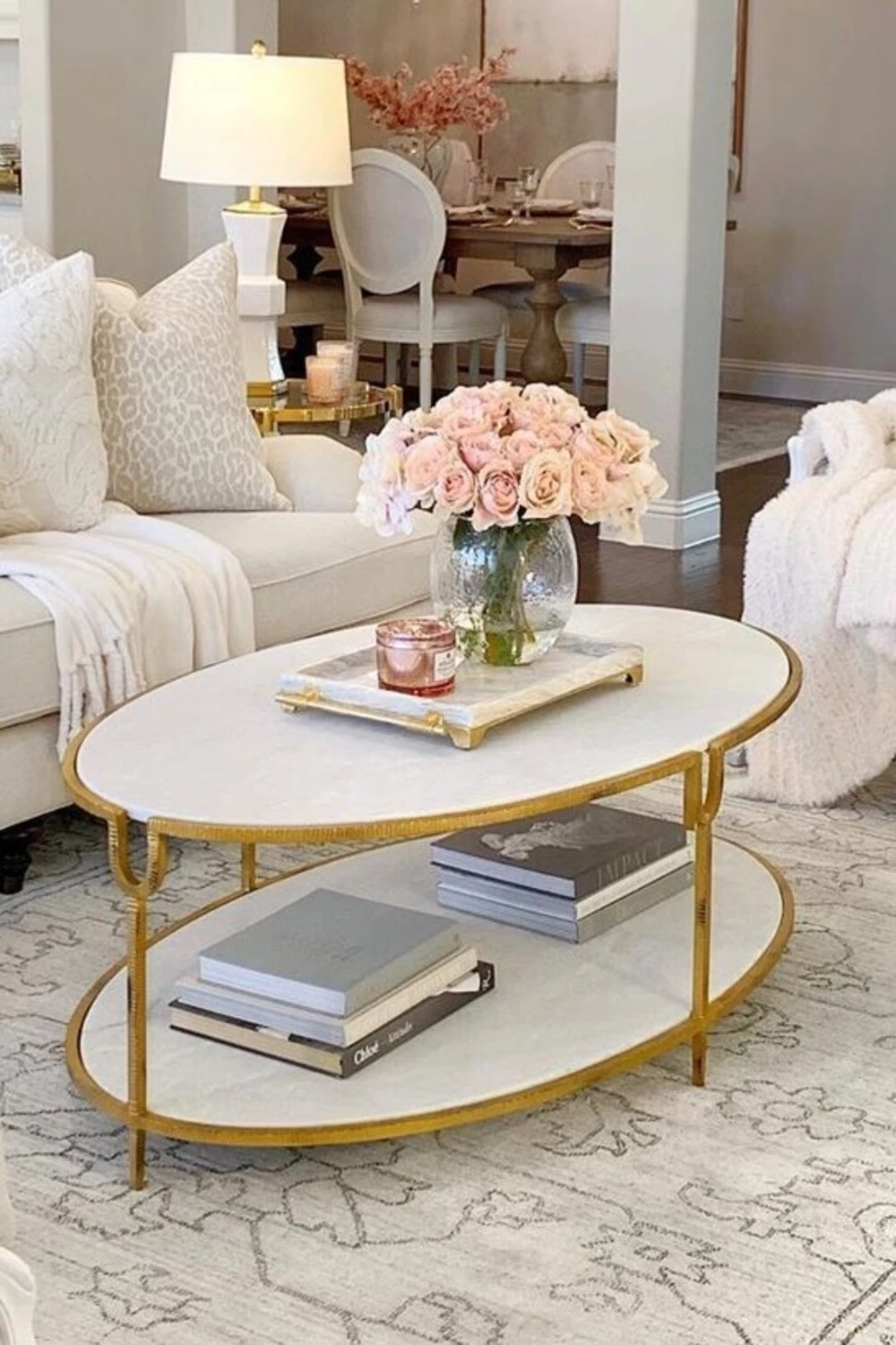 an oval coffee table with pink flowers