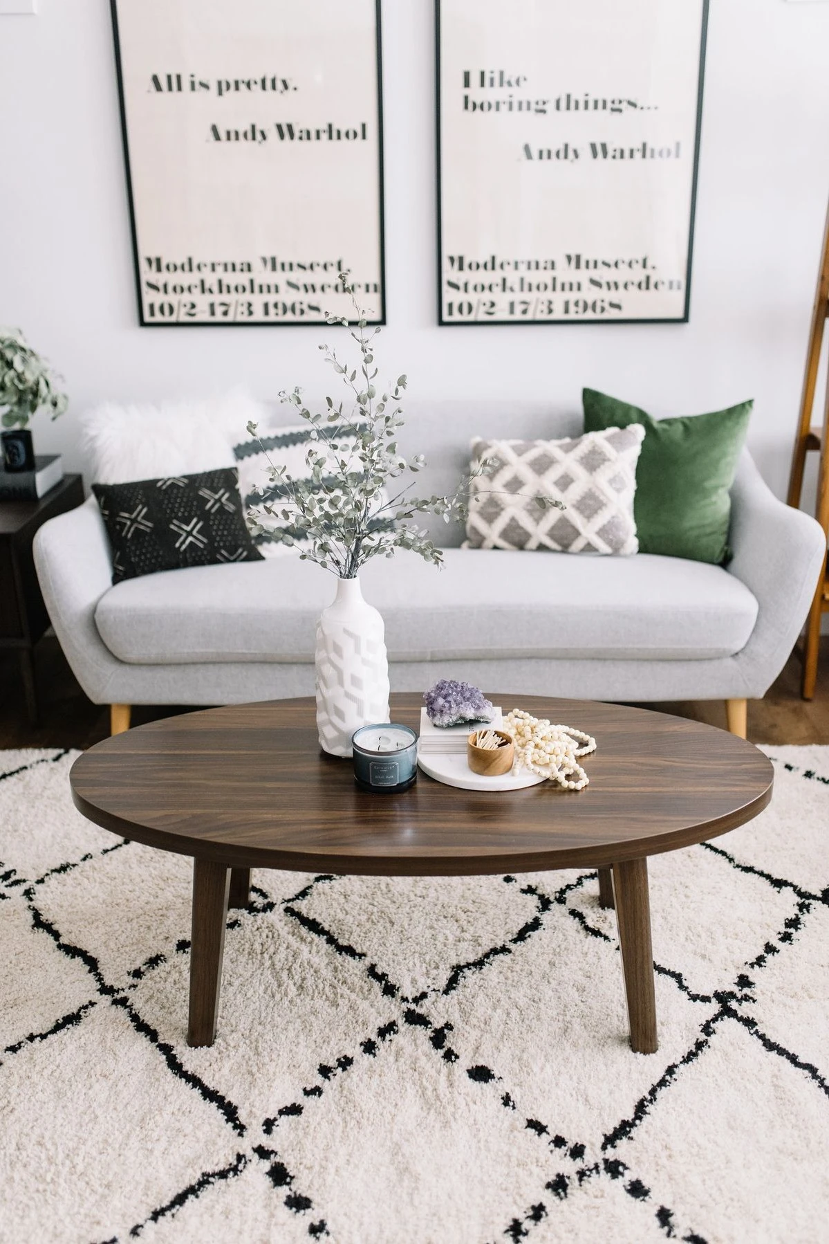an oval coffee table with wood bead and plant