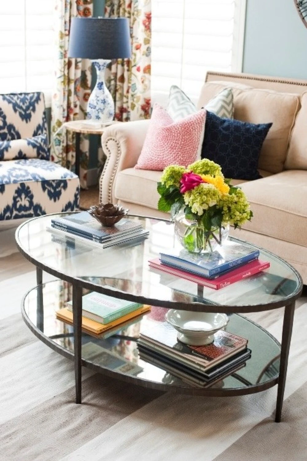 an oval glass coffee table with colorful flowers