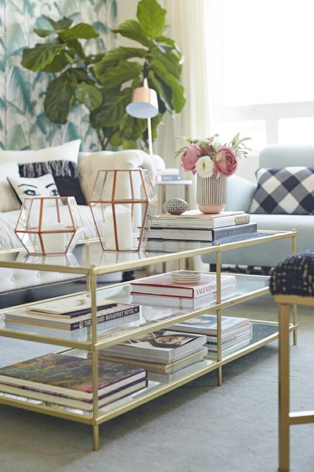a rectangle glass coffee table with books and candles