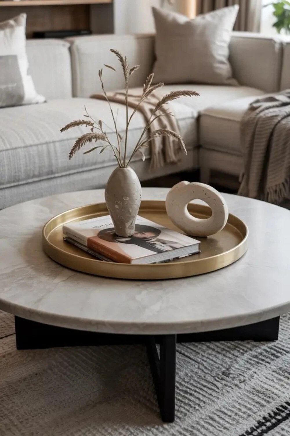 a round coffee table with a brass tray