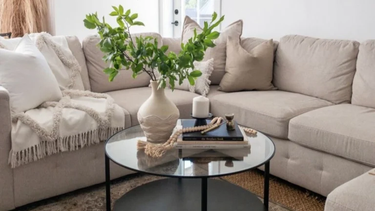 a round glass coffee table with plants and bone bead