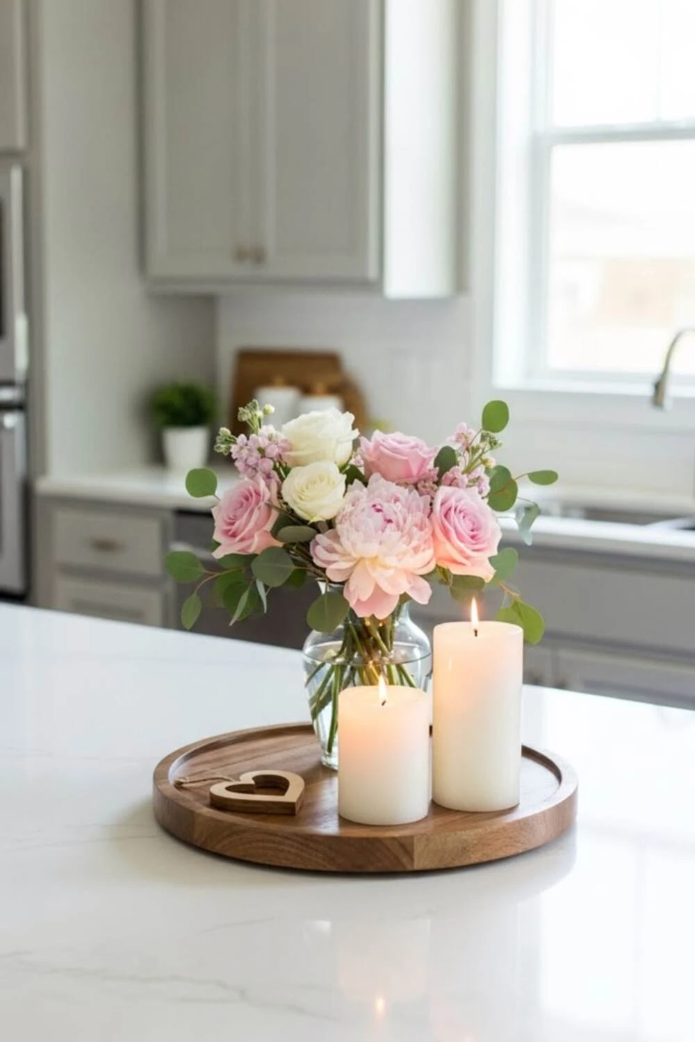 a kitchen island countertop decorated with pink flower and candles