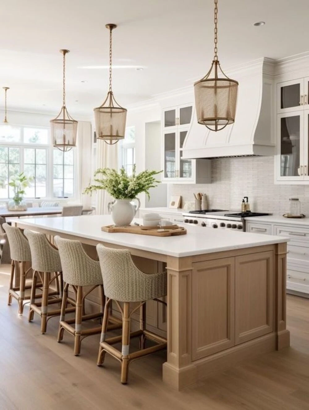 a large kitchen island decorated with a vase and some bowls on board