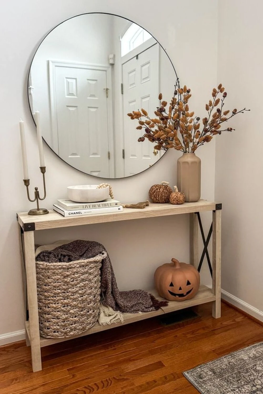 a small entryway with fall decor