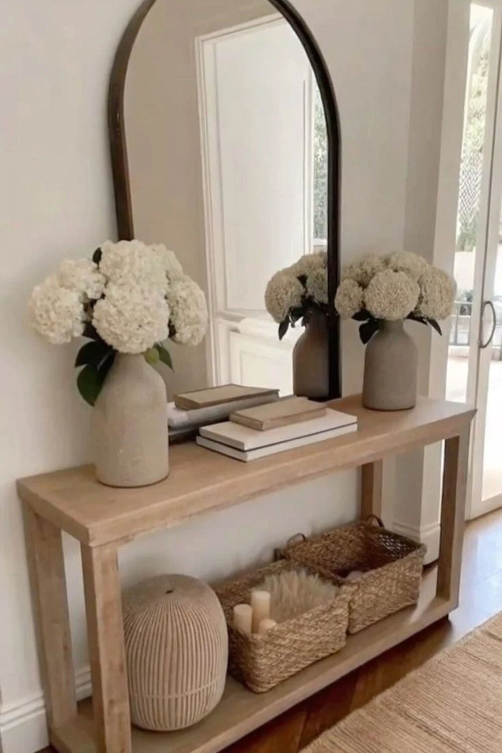 a small entryway with a large mirror