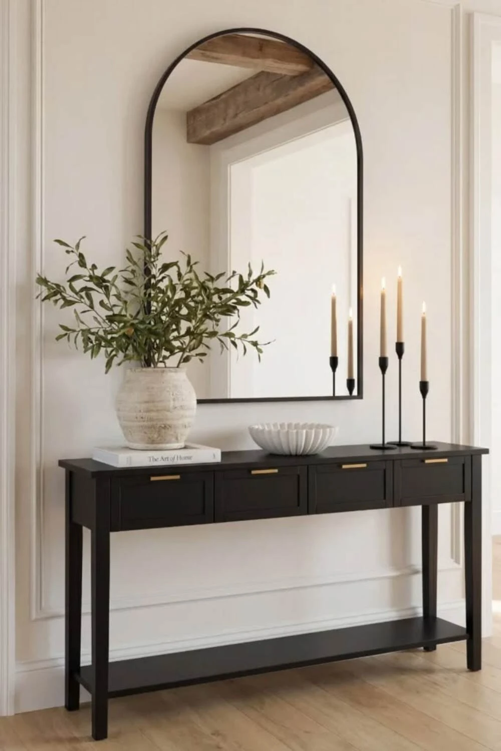 an entryway mirror with black frame