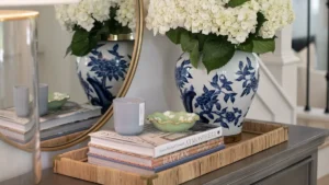 an entryway tray with books and flowers