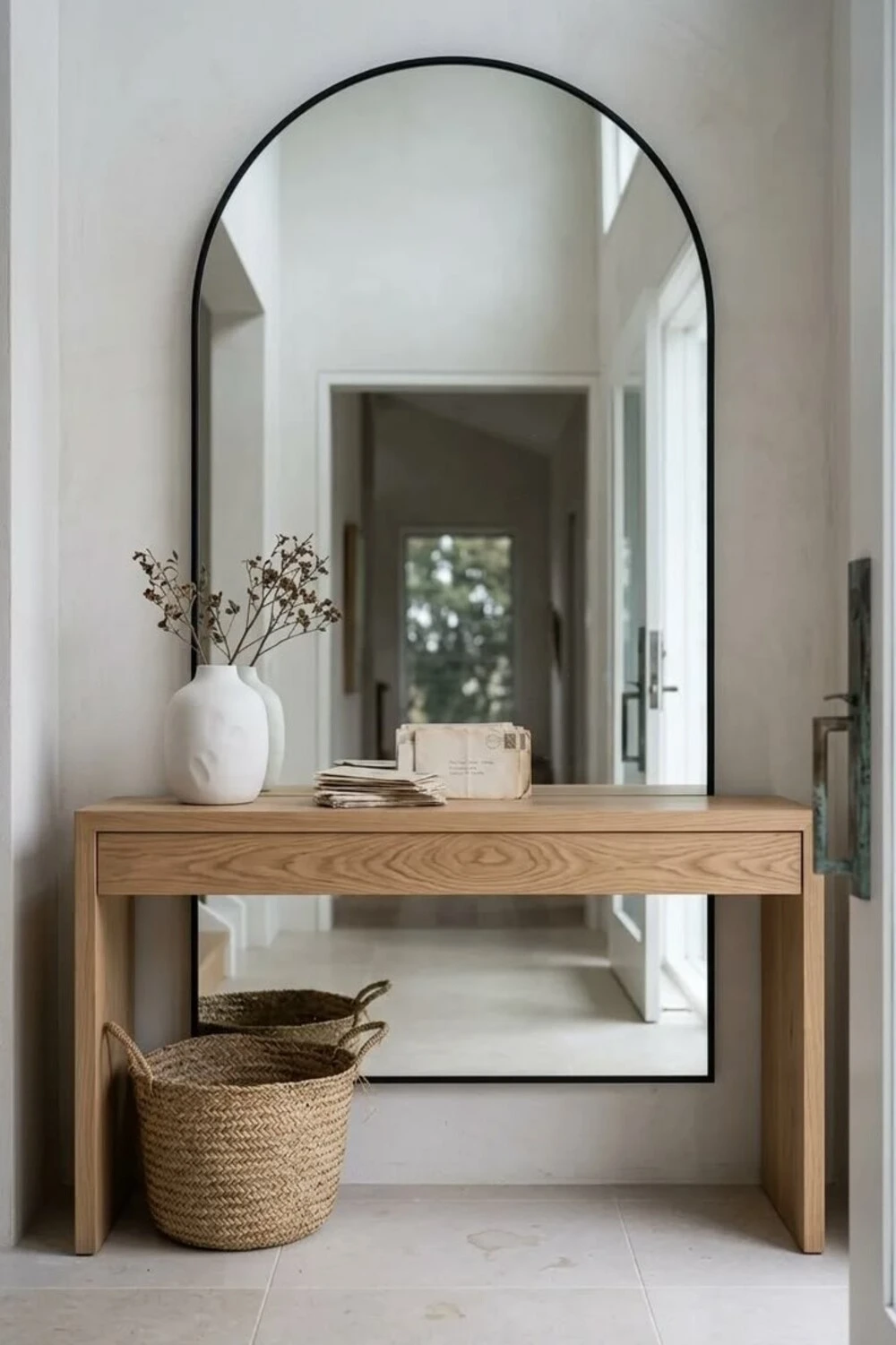 an entryway with oversized mirror