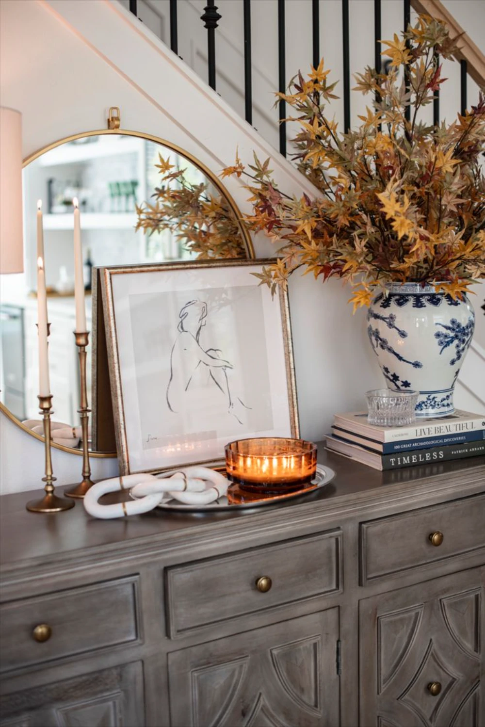 a mirrored tray on console table
