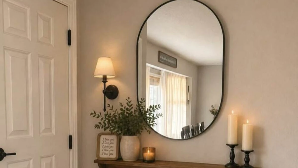a small entryway with arched mirror